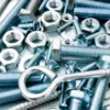 Nuts screws and bolts on scratched metal background